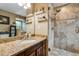 Bathroom boasts granite countertop and walk-in shower at 10399 Zenobia Ct, Westminster, CO 80031