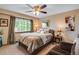 Cozy guest bedroom with window seating and ceiling fan at 10399 Zenobia Ct, Westminster, CO 80031