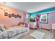 Charming bedroom with pink and teal decor at 10399 Zenobia Ct, Westminster, CO 80031