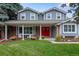 Two-story house with gray siding, red door, and landscaped lawn at 10399 Zenobia Ct, Westminster, CO 80031