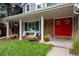 Inviting front porch with red double doors and white columns at 10399 Zenobia Ct, Westminster, CO 80031