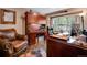 Home office with wood desk, leather chair, and built-in shelving at 10399 Zenobia Ct, Westminster, CO 80031