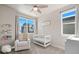 Bedroom with a crib, rocking chair, and plenty of natural light at 5671 Emporia St, Denver, CO 80238