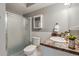 Bathroom with shower stall, large sink, white tile and decor at 710 S Clinton St # 3A, Denver, CO 80247