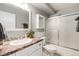 Bathroom featuring a vanity and bath tub with shower and frosted glass doors at 710 S Clinton St # 3A, Denver, CO 80247