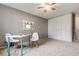 Bedroom featuring white work desk, chair and large closet space with ceiling fan at 710 S Clinton St # 3A, Denver, CO 80247