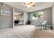 Bedroom featuring neutral carpet and views to the living room and work space at 710 S Clinton St # 3A, Denver, CO 80247