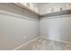 Empty walk-in closet with storage shelves and neutral carpeting at 710 S Clinton St # 3A, Denver, CO 80247