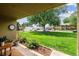Covered patio with view of lush green front lawn and mature shade tree at 710 S Clinton St # 3A, Denver, CO 80247