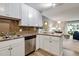 Bright kitchen with stainless steel appliances, light countertops, and white cabinets with stylish hardware at 710 S Clinton St # 3A, Denver, CO 80247
