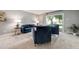 Spacious living room featuring blue furniture and a sliding glass door to the outside at 710 S Clinton St # 3A, Denver, CO 80247