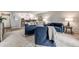 Open-concept living area with contemporary blue furniture and kitchen access at 710 S Clinton St # 3A, Denver, CO 80247