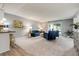 Spacious living area with sliding glass door, modern furnishings, and a decorative cabinet at 710 S Clinton St # 3A, Denver, CO 80247