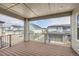 Covered deck/balcony showcasing scenic neighborhood views and wood flooring at 8822 Fraser River Loop, Littleton, CO 80125