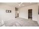 Light and airy bedroom features neutral carpet, fan, and multiple windows at 8822 Fraser River Loop, Littleton, CO 80125
