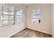 Bright bedroom features three large windows providing ample natural light and hardwood floors at 8822 Fraser River Loop, Littleton, CO 80125