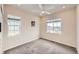Bright bedroom featuring neutral walls, carpeted floor, ceiling fan and natural light at 8822 Fraser River Loop, Littleton, CO 80125