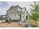 Two-story home featuring gray siding, landscaped front yard, and inviting walkway at 8822 Fraser River Loop, Littleton, CO 80125