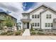 Charming two-story home featuring white siding, landscaped front yard, and inviting walkway at 8822 Fraser River Loop, Littleton, CO 80125