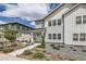 Charming two-story home featuring white siding, landscaped front yard, and inviting walkway at 8822 Fraser River Loop, Littleton, CO 80125
