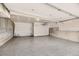 Spacious garage with epoxy floor, ample storage space, and overhead lighting at 8822 Fraser River Loop, Littleton, CO 80125