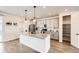 Bright, open kitchen with gray cabinets, granite countertops, and a spacious island with modern pendant lighting at 8822 Fraser River Loop, Littleton, CO 80125