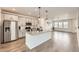 Modern kitchen with stainless steel appliances, granite countertops, and a large center island at 8822 Fraser River Loop, Littleton, CO 80125