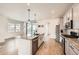Modern kitchen featuring granite countertops, stainless steel appliances, and stylish pendant lighting at 8822 Fraser River Loop, Littleton, CO 80125