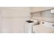 Functional laundry room with modern washer and dryer units and storage shelves at 8822 Fraser River Loop, Littleton, CO 80125