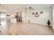 Open-concept living area with wood floors, modern lighting, and seamless flow to the kitchen at 8822 Fraser River Loop, Littleton, CO 80125