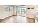 Open-concept living area with sliding glass doors to balcony and modern hardwood floors, great for entertaining at 8822 Fraser River Loop, Littleton, CO 80125