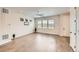 Bright living room with wood floors, ceiling fan, and large windows with scenic views at 8822 Fraser River Loop, Littleton, CO 80125