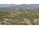 Lush forest surrounds hillside homes and winding roads with distant mountain views and natural serene environment at 11390 Shimley Rd, Golden, CO 80403