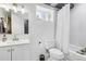 Clean, all-white bathroom featuring a shower, toilet, and vanity with a bright, well-lit mirror at 11390 Shimley Rd, Golden, CO 80403