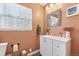 Bathroom with a white single sink vanity, decorative mirror, and a window with natural light at 11390 Shimley Rd, Golden, CO 80403