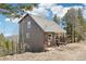 Charming exterior elevation showing the house nestled among the trees at 11390 Shimley Rd, Golden, CO 80403