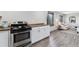 Kitchen with stainless steel oven and butcher block countertops, flowing into the cozy living room at 11390 Shimley Rd, Golden, CO 80403