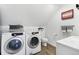 Laundry room featuring a stackable washer/dryer, toilet, sink and modern finishes at 11390 Shimley Rd, Golden, CO 80403