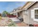 The backyard boasts a multi-tiered layout including a deck with patio, storage and brick pavers at 2741 Poplar Grove Pl, Castle Rock, CO 80109