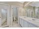 Well-lit bathroom with dual sinks, a spacious vanity, and separate toilet and shower areas at 2741 Poplar Grove Pl, Castle Rock, CO 80109