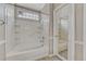 Bright bathroom features a tiled shower-over-tub with a grab bar and built-in shelving at 2741 Poplar Grove Pl, Castle Rock, CO 80109