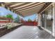 View of the covered patio featuring an awning over the deck, a view of the landscaped yard, and entry to the home at 2741 Poplar Grove Pl, Castle Rock, CO 80109