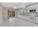 Kitchen with sliding glass doors to outdoor deck, featuring white cabinets, tiled backsplash, and stainless steel appliances at 2741 Poplar Grove Pl, Castle Rock, CO 80109