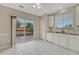 Bright kitchen featuring white cabinets, granite countertops, tile backsplash, and a sliding glass door at 2741 Poplar Grove Pl, Castle Rock, CO 80109