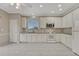 Bright kitchen featuring white cabinets, granite countertops, tile backsplash, and stainless microwave at 2741 Poplar Grove Pl, Castle Rock, CO 80109