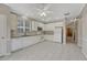 Bright kitchen featuring white cabinets, granite countertops, tile backsplash, and stainless microwave at 2741 Poplar Grove Pl, Castle Rock, CO 80109