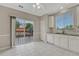 Kitchen with sliding glass doors to outdoor deck, featuring white cabinets, tiled backsplash, and stainless steel appliances at 2741 Poplar Grove Pl, Castle Rock, CO 80109