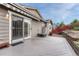 Inviting patio with sliding glass door, awning, stone landscaping, and privacy fence at 2741 Poplar Grove Pl, Castle Rock, CO 80109