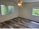 Bright bedroom with ceiling fan, large windows, and updated flooring at 2815 S Dexter Way, Denver, CO 80222