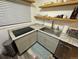 Modern kitchen featuring granite countertops, stainless steel appliances, and floating shelves at 2815 S Dexter Way, Denver, CO 80222